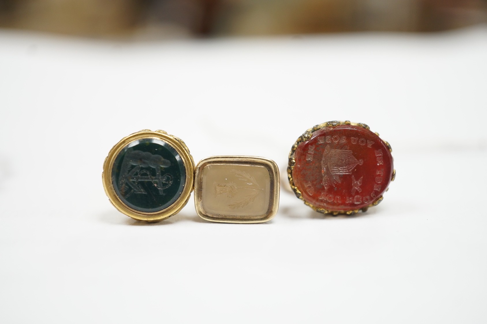 A collection of twelve small 19th century mainly yellow metal fob seals, with assorted matrices including bloodstone, amethyst, citrine and carnelian, largest 22mm.
